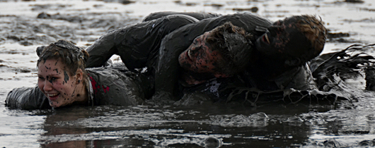 muddy perople during the mud olympics in Brunsbuettel 2012